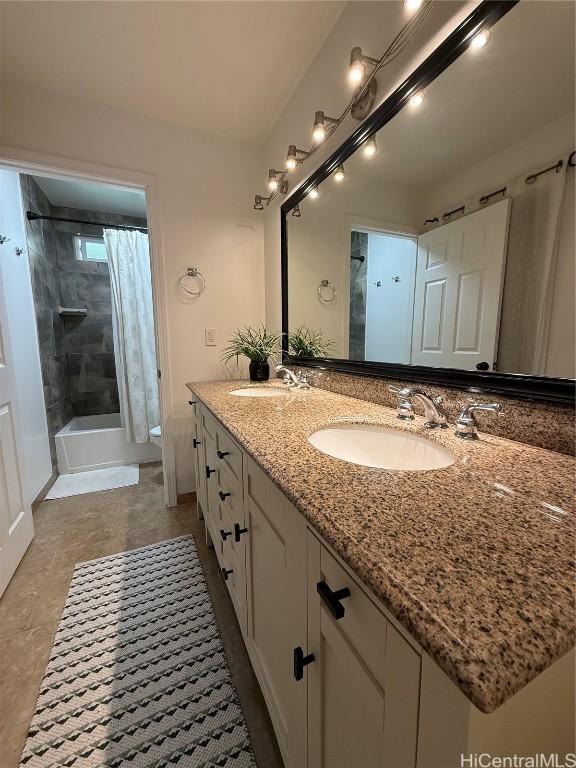 bathroom featuring shower / bath combination with curtain, a sink, and double vanity