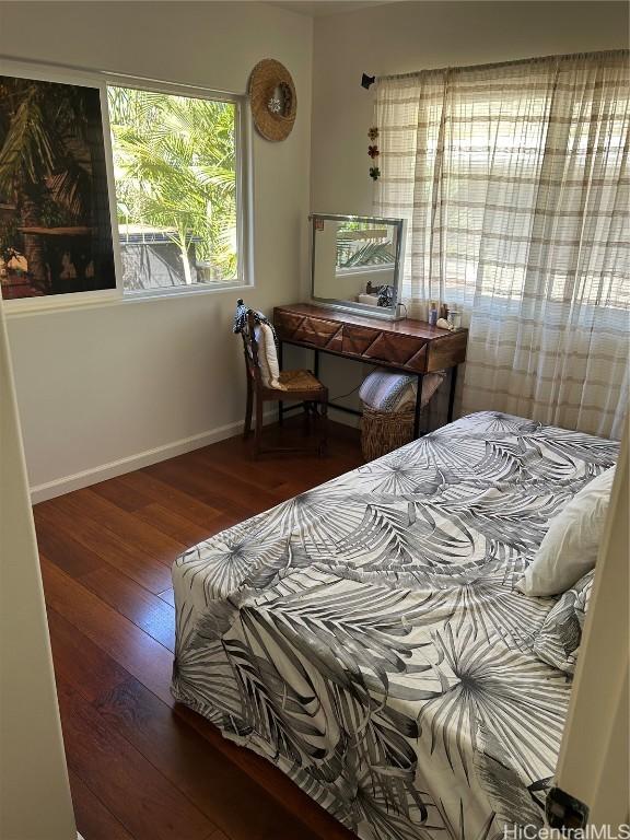 bedroom featuring hardwood / wood-style floors and baseboards