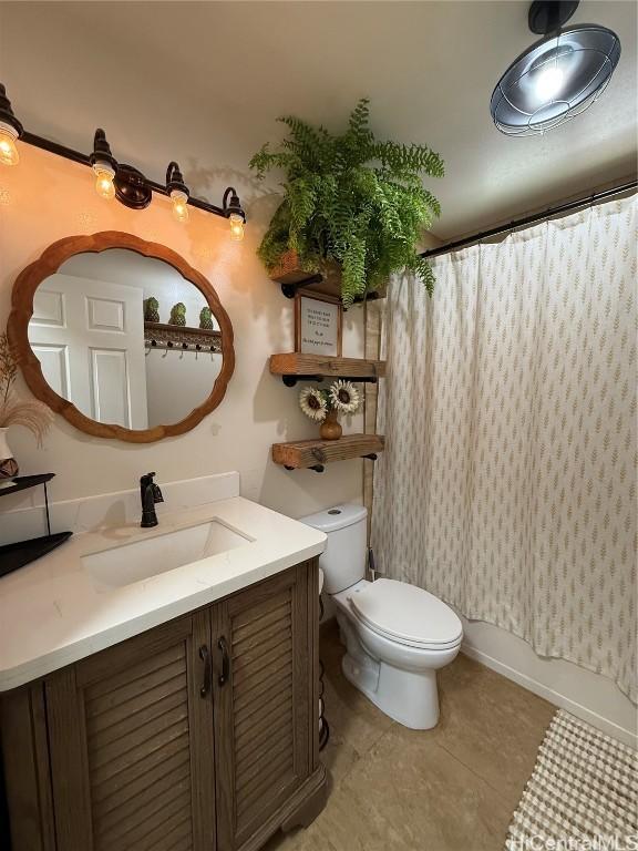 full bathroom with tile patterned flooring, vanity, toilet, and shower / bath combo with shower curtain