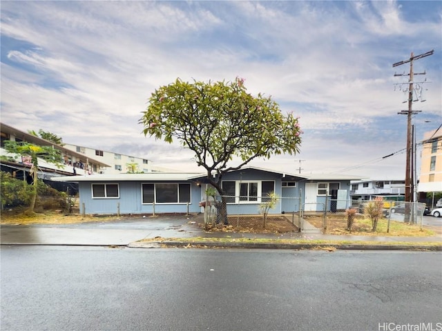 ranch-style house featuring fence