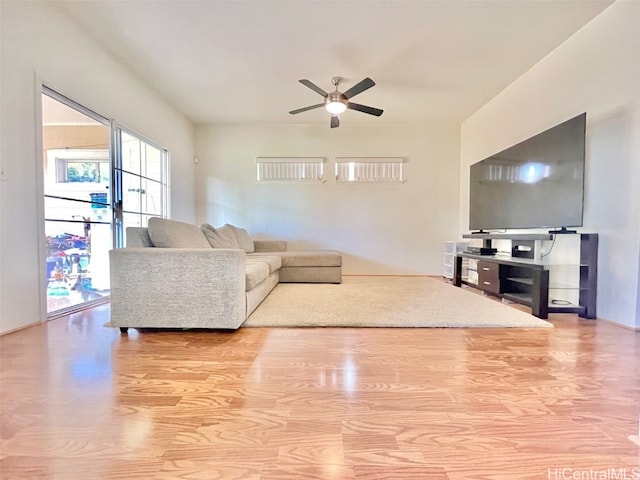 living room featuring ceiling fan and wood finished floors