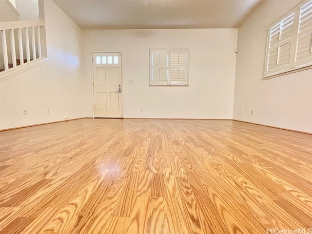 unfurnished living room featuring wood finished floors