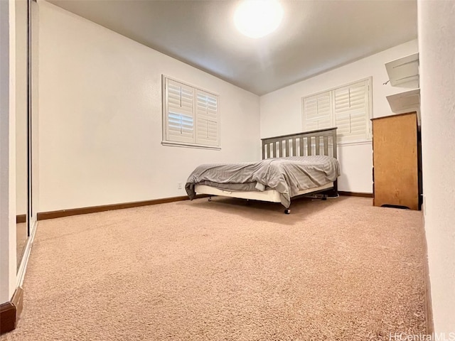 carpeted bedroom featuring baseboards