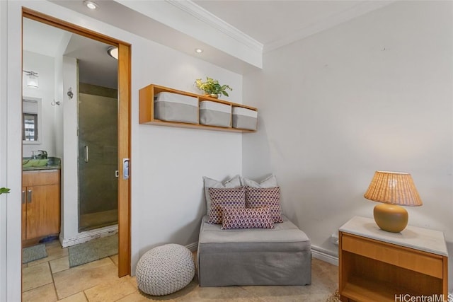 sitting room featuring baseboards and ornamental molding