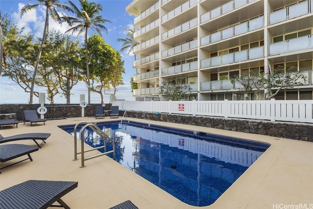 community pool featuring a patio area and fence