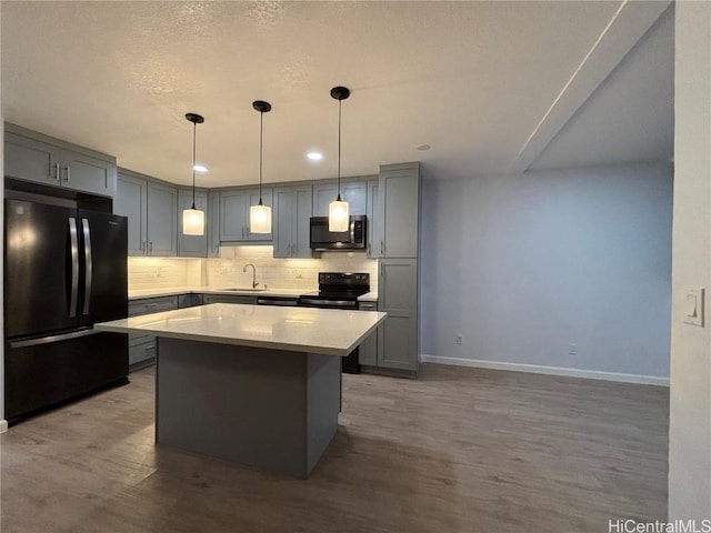 kitchen with gray cabinets, backsplash, and black appliances