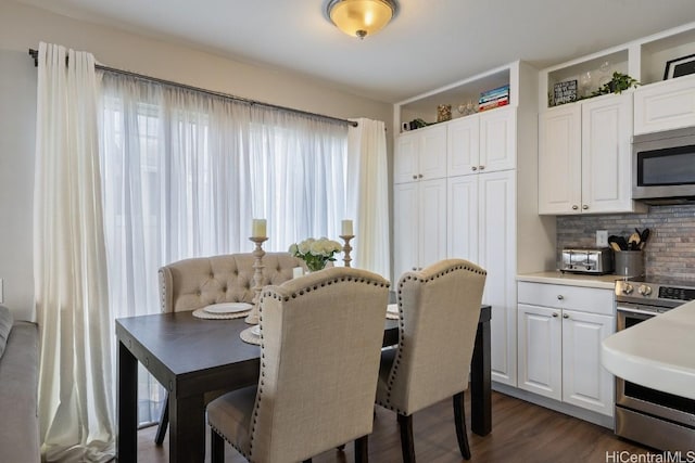 dining area featuring dark wood-style floors