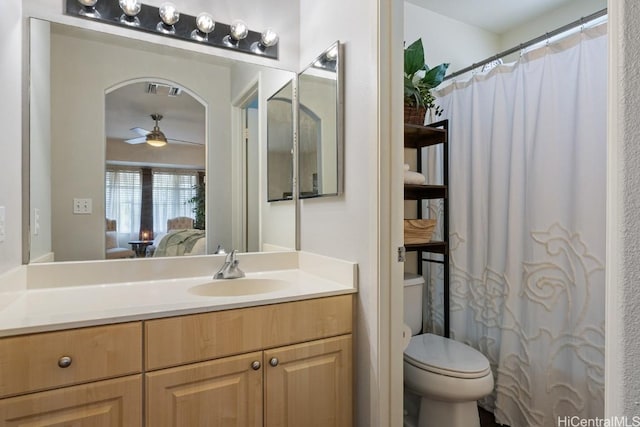 full bath featuring visible vents, connected bathroom, toilet, vanity, and a ceiling fan