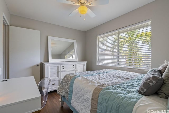 bedroom with dark wood-style floors and a ceiling fan