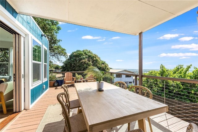 wooden terrace with outdoor dining area