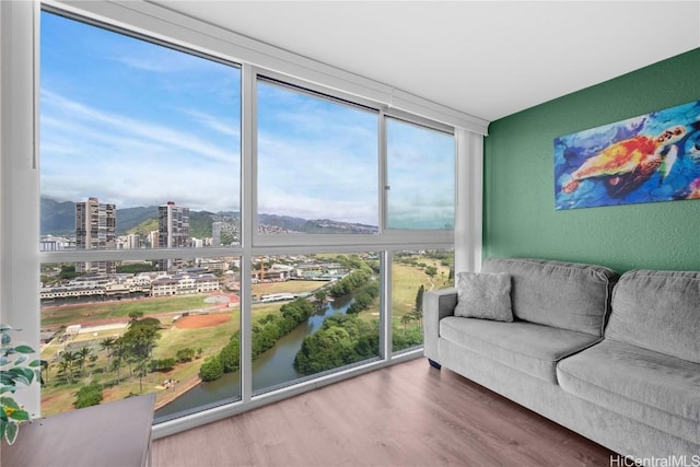 2211 Ala Wai Blvd Unit 2414, Honolulu, HI 96815 - interior space featuring a city view, a wall of windows, a textured wall, and wood finished floors