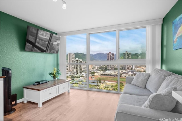 2211 Ala Wai Blvd Unit 2414, Honolulu, HI 96815 - living area with floor to ceiling windows, a textured wall, and light wood-type flooring