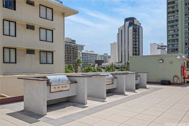 2211 Ala Wai Blvd Unit 2414, Honolulu, HI 96815 - view of patio / terrace featuring a city view, exterior kitchen, and grilling area