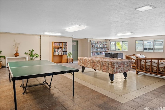 2211 Ala Wai Blvd Unit 2414, Honolulu, HI 96815 - recreation room with built in shelves, a textured ceiling, and tile patterned flooring