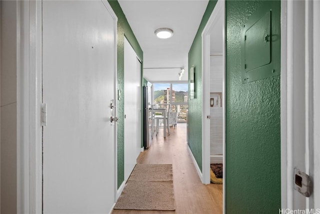 2211 Ala Wai Blvd Unit 2414, Honolulu, HI 96815 - corridor featuring floor to ceiling windows, light wood-style flooring, electric panel, and a textured wall