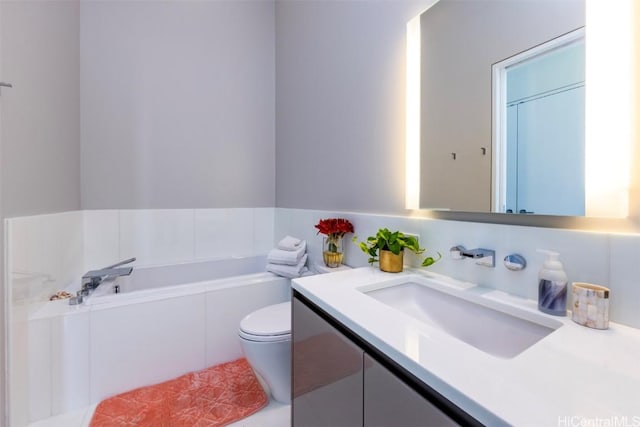 full bathroom with toilet, a garden tub, and vanity