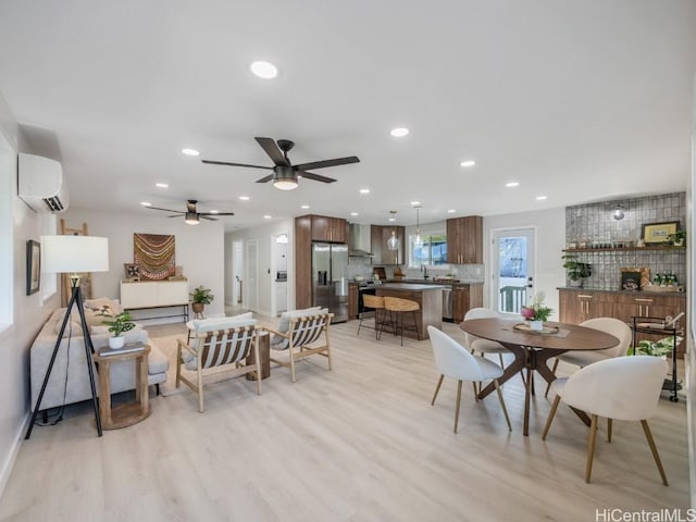 dining space with light wood-style flooring, recessed lighting, and a wall mounted AC