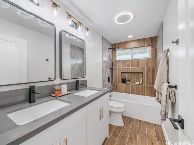 full bathroom with a sink, toilet, wood tiled floor, and shower / bathtub combination