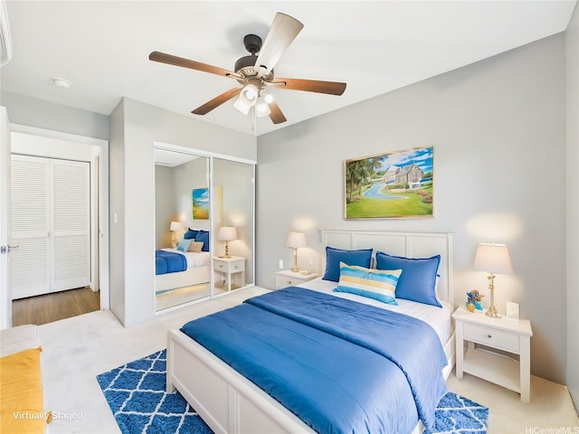 bedroom with carpet flooring, a closet, and ceiling fan