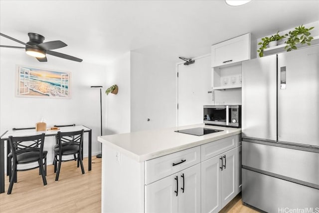 kitchen featuring stainless steel appliances, white cabinets, light wood finished floors, and open shelves