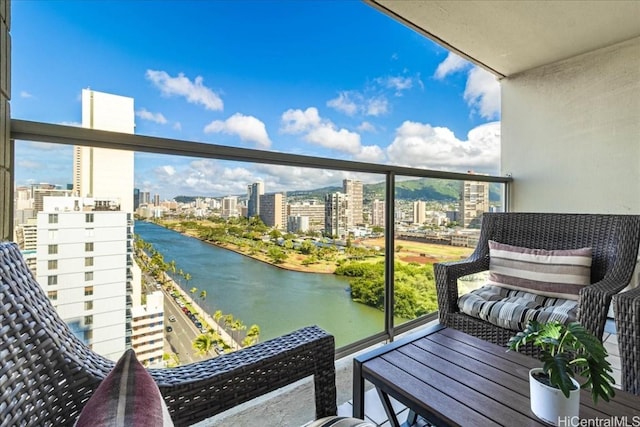 balcony featuring a view of city and a water view