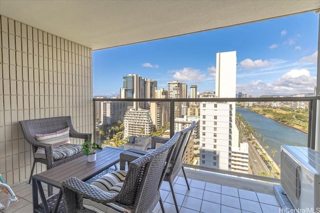 balcony featuring a city view and a water view