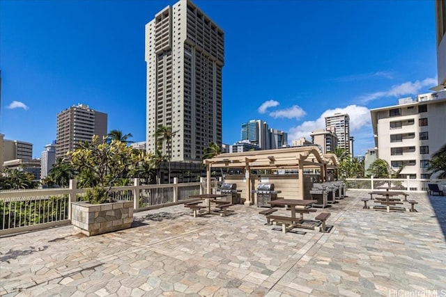 view of patio with a city view and grilling area