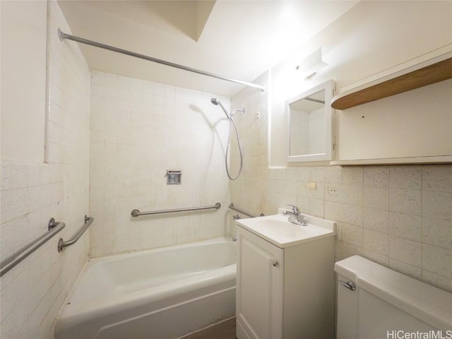 bathroom with  shower combination, tile walls, toilet, and vanity