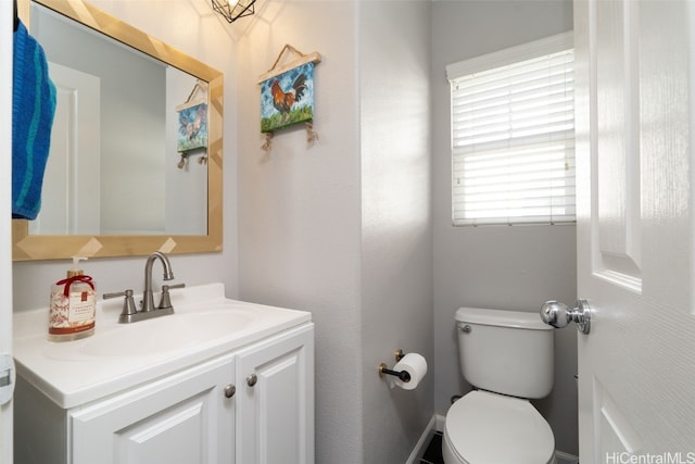 half bath featuring toilet and vanity