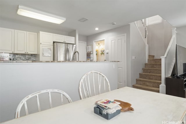 dining room with stairs and recessed lighting