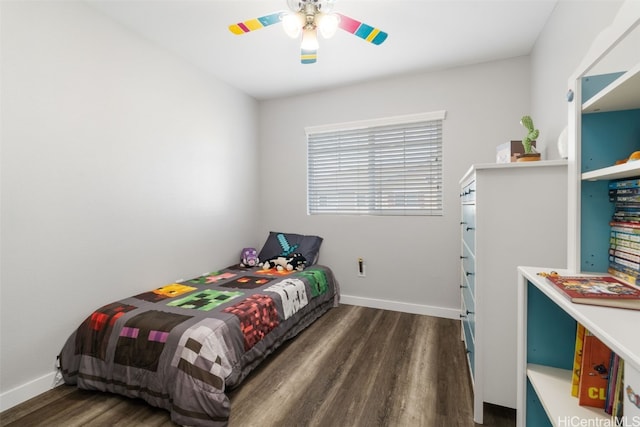 bedroom with a ceiling fan, baseboards, and wood finished floors