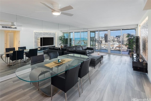 dining space featuring wood finished floors, visible vents, and ceiling fan