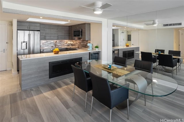 interior space with visible vents, wine cooler, and a ceiling fan