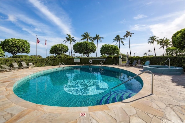 pool featuring a patio area, a community hot tub, and fence