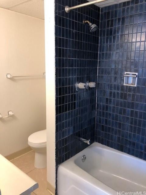 full bath with shower / washtub combination, tile patterned flooring, and toilet