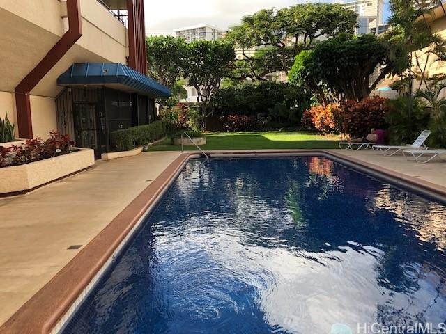 outdoor pool with a patio area