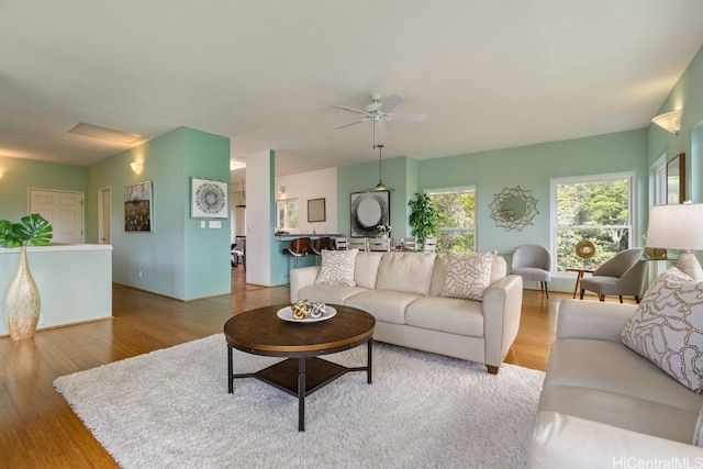 living area featuring wood finished floors and a ceiling fan