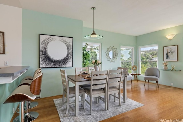 dining area with plenty of natural light and wood finished floors