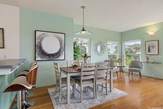 dining area featuring a healthy amount of sunlight and wood finished floors