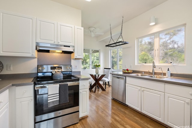 kitchen featuring ceiling fan, a sink, white cabinets, under cabinet range hood, and stainless steel appliances