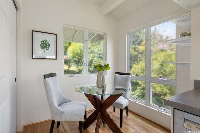 sunroom / solarium with beamed ceiling, plenty of natural light, and french doors
