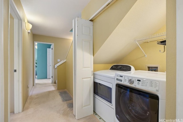 washroom featuring light carpet, laundry area, and washing machine and dryer