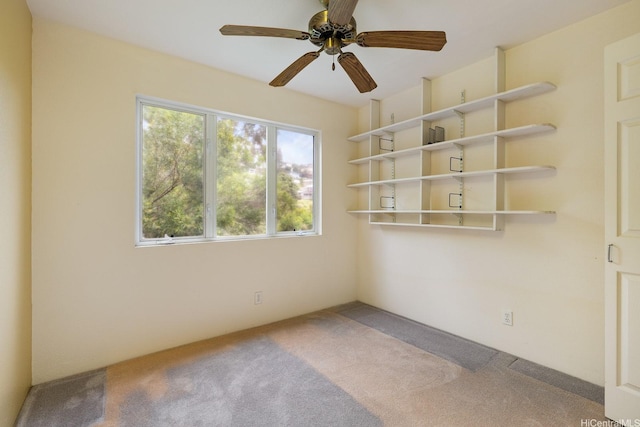 unfurnished room with carpet floors and a ceiling fan