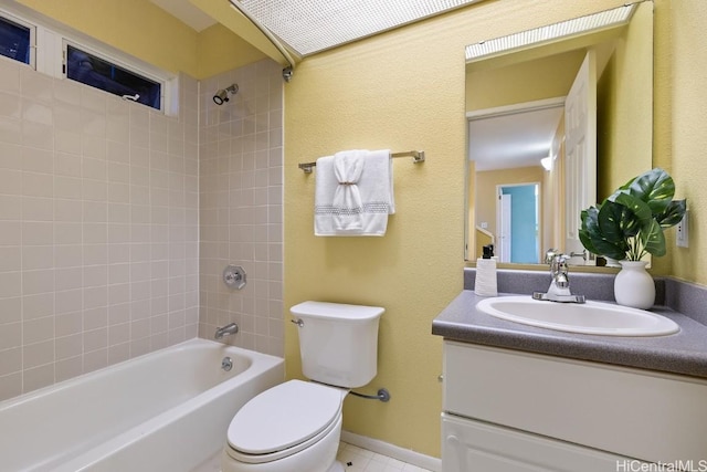 bathroom with washtub / shower combination, vanity, toilet, and baseboards