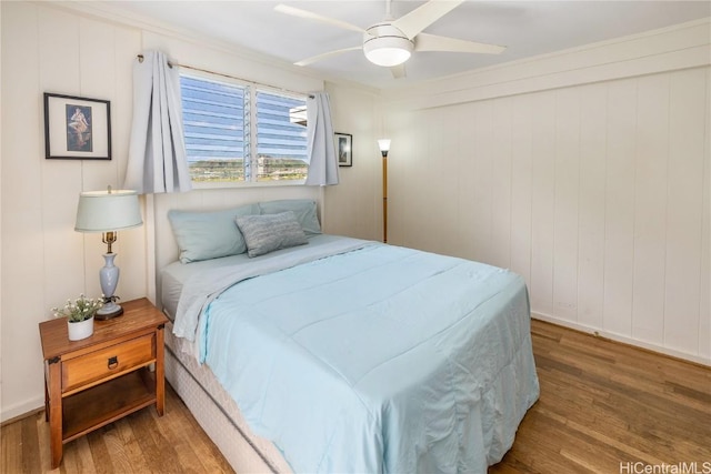 bedroom with a ceiling fan and wood finished floors