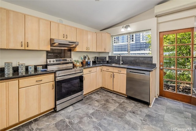 kitchen with under cabinet range hood, stainless steel appliances, and light brown cabinetry