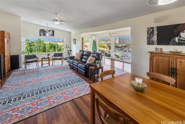 living area with wood finished floors, ceiling fan, and vaulted ceiling