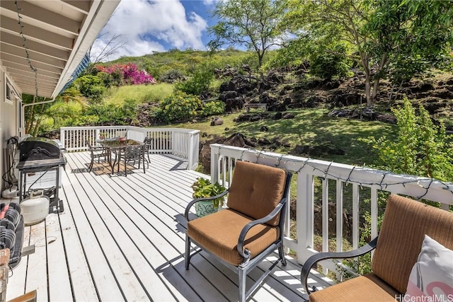 wooden terrace with outdoor dining area