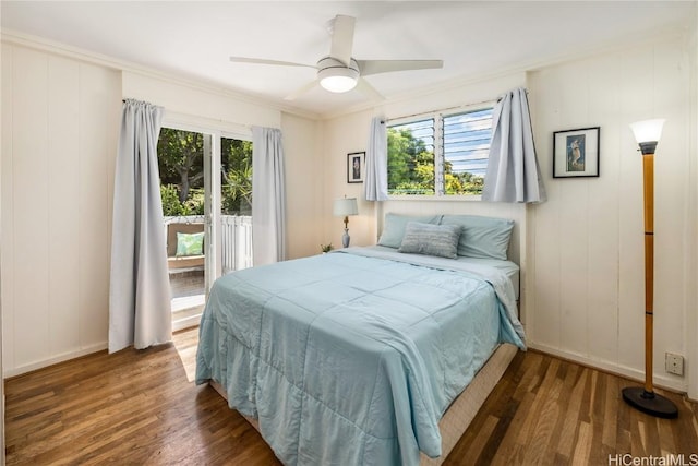 bedroom with a ceiling fan, access to outside, wood finished floors, crown molding, and baseboards