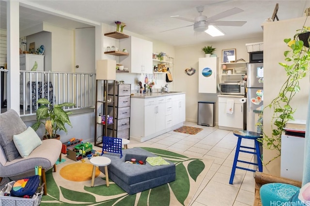 living area with a toaster, light tile patterned flooring, and ceiling fan